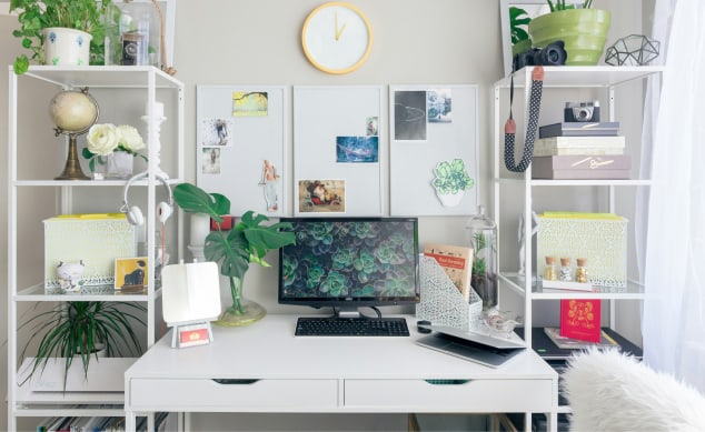Organized desk with notebooks and computers with plants and office stuff